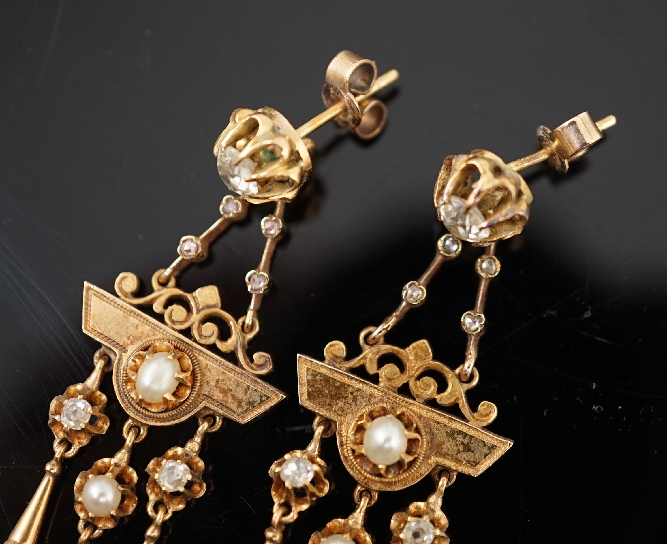 A pair of Victorian gold, seven stone diamond and two stone pearl set triple drop earrings, of aesthetic design